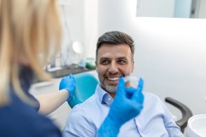 dentist showing patient an aligner